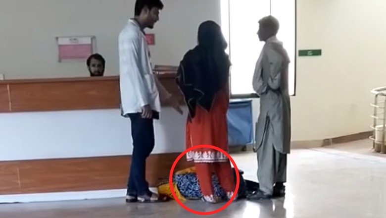 Woman suffering from a heart problem awaits treatment on the floor of Larkana Hospital