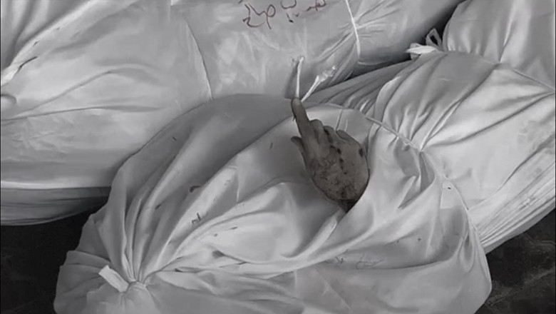 Deceased Palestinian man raises index finger in shahada gesture